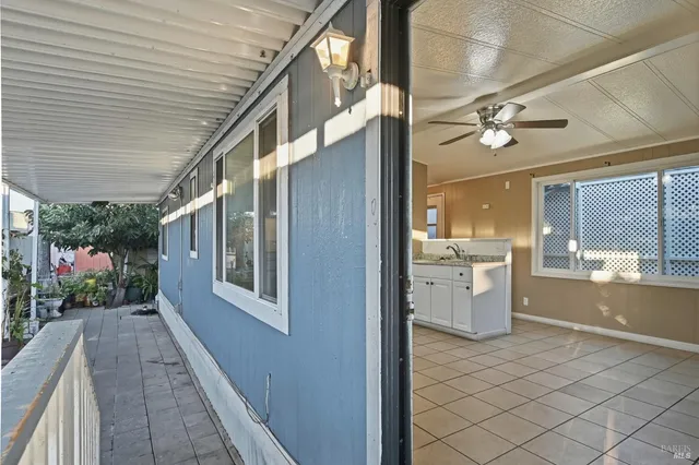 a view of a hallway with a dining table and chairs