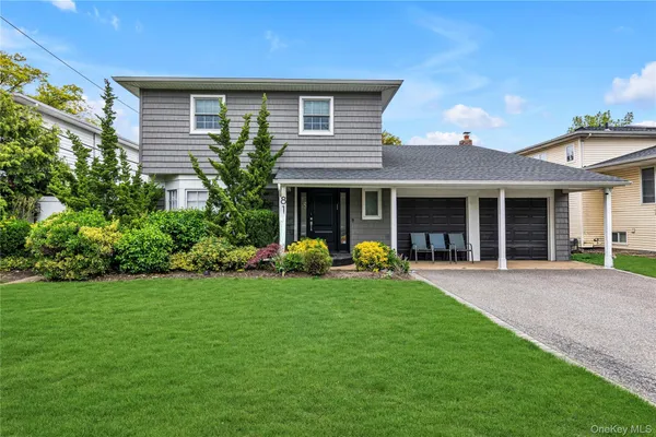 a front view of a house with a yard and porch