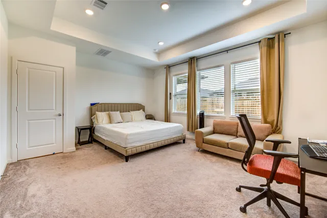 a bedroom with a bed and a couch