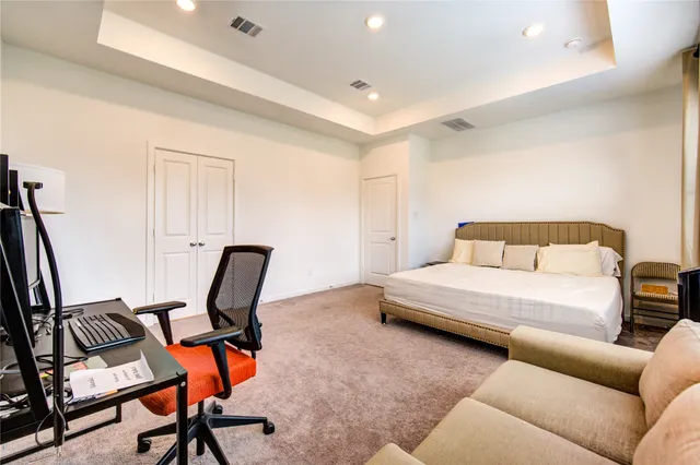 a bedroom with a bed a couch and chair