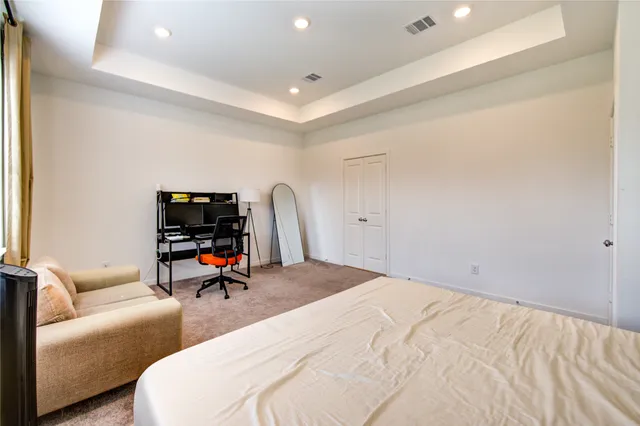 a bedroom with a bed and a chair