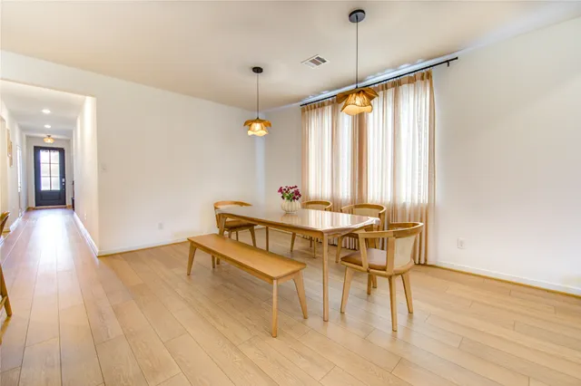a view of a dining room with furniture window and wooden floor