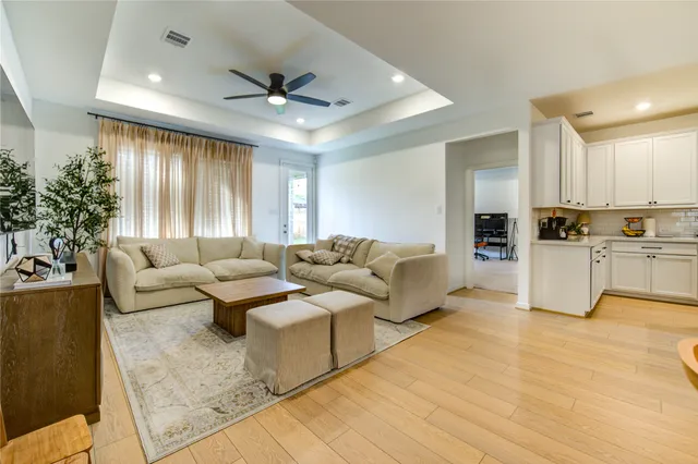 a living room with furniture and kitchen view