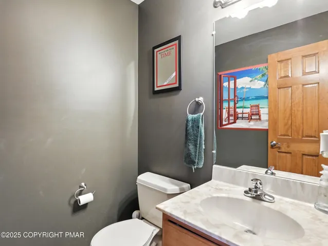 a bathroom with a sink mirror and toilet