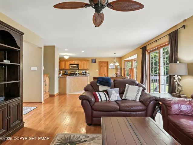 a living room with furniture and a floor to ceiling window
