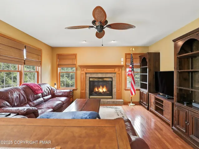 a living room with furniture a flat screen tv and a fireplace
