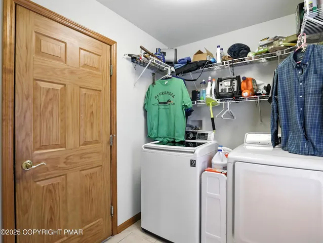 a view of storage and utility room with washer and dryer