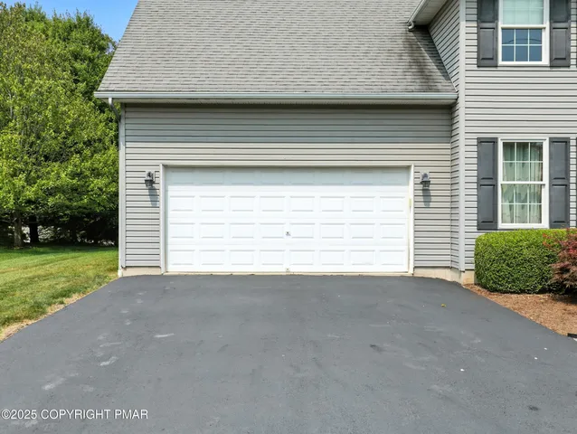 a view of a house with a small yard and a large window