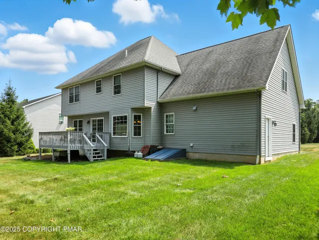 a view of a house with a yard and sitting area
