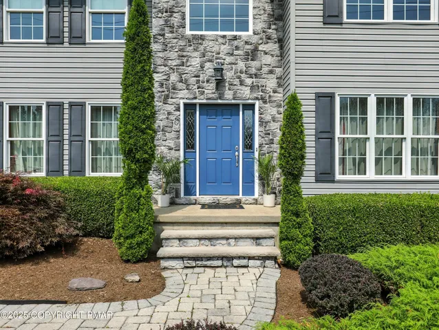 a view of a house with windows and plants