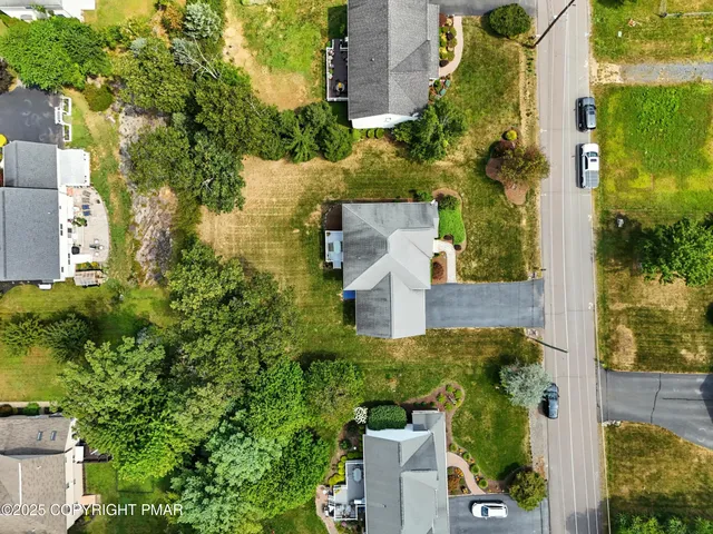 an aerial view of a house with outdoor space