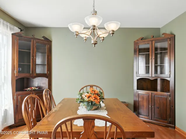 a view of a dining room with furniture and chandelier