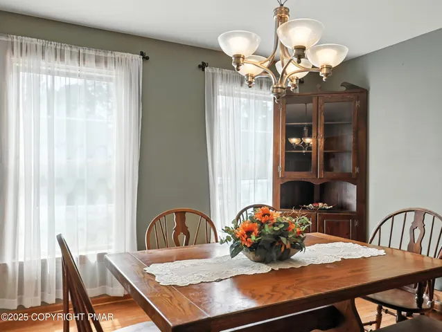 a view of a dining room with furniture and chandelier