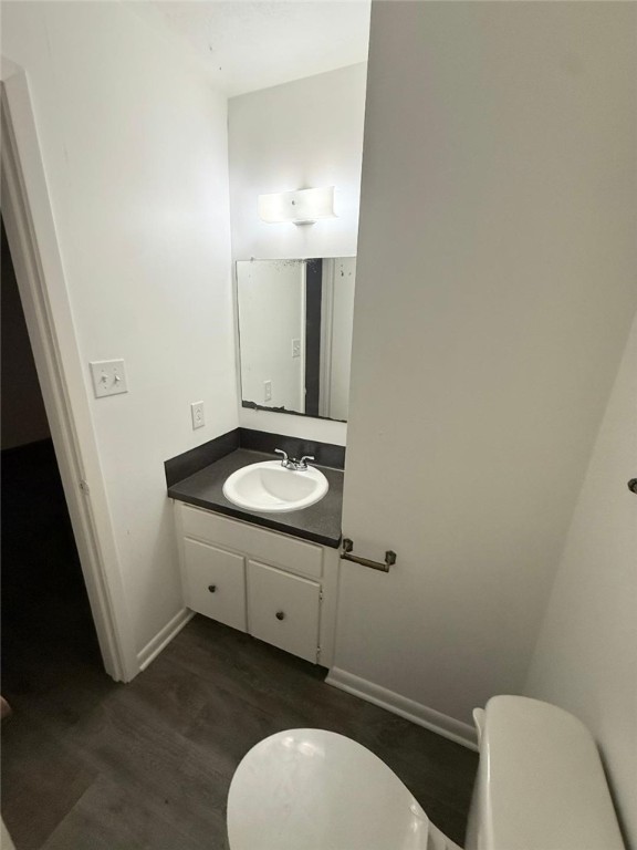 4211 Marsh Street Bryan, TX 77803 - Photo 12 of 13 a bathroom with a granite countertop toilet sink and mirror