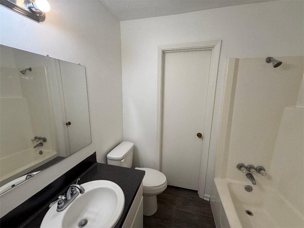 4211 Marsh Street Bryan, TX 77803 - Photo 12 of 15 a bathroom with a granite countertop toilet and a sink