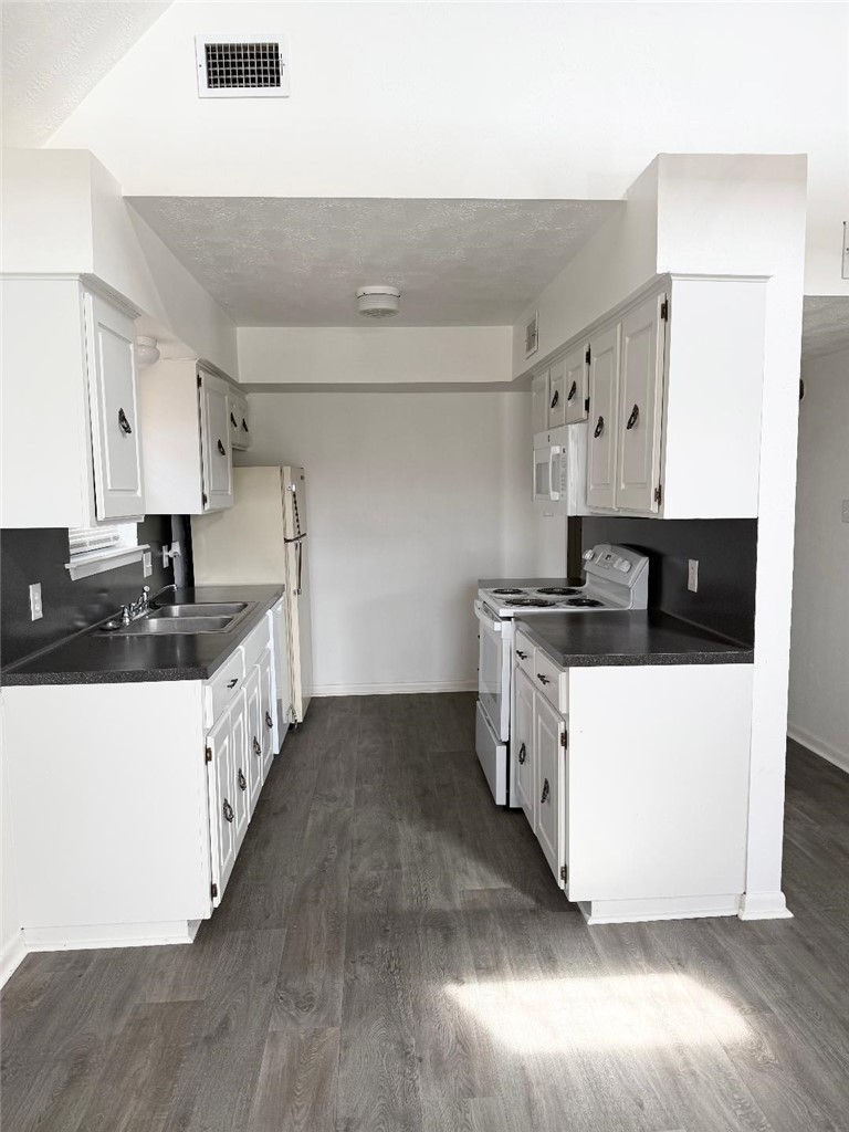 4211 Marsh Street Bryan, TX 77803 - Photo 5 of 15 a large white kitchen with wooden floor