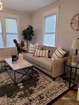 a living room with furniture and a table