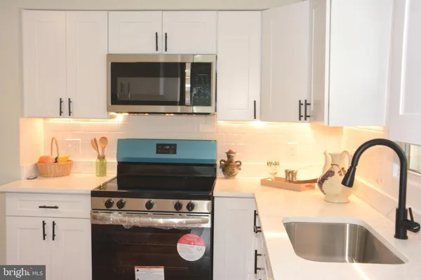 a kitchen with a stove and a microwave
