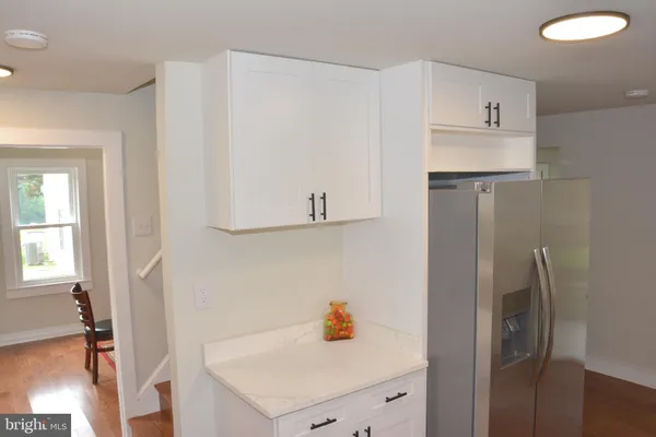 a kitchen with a refrigerator and cabinets