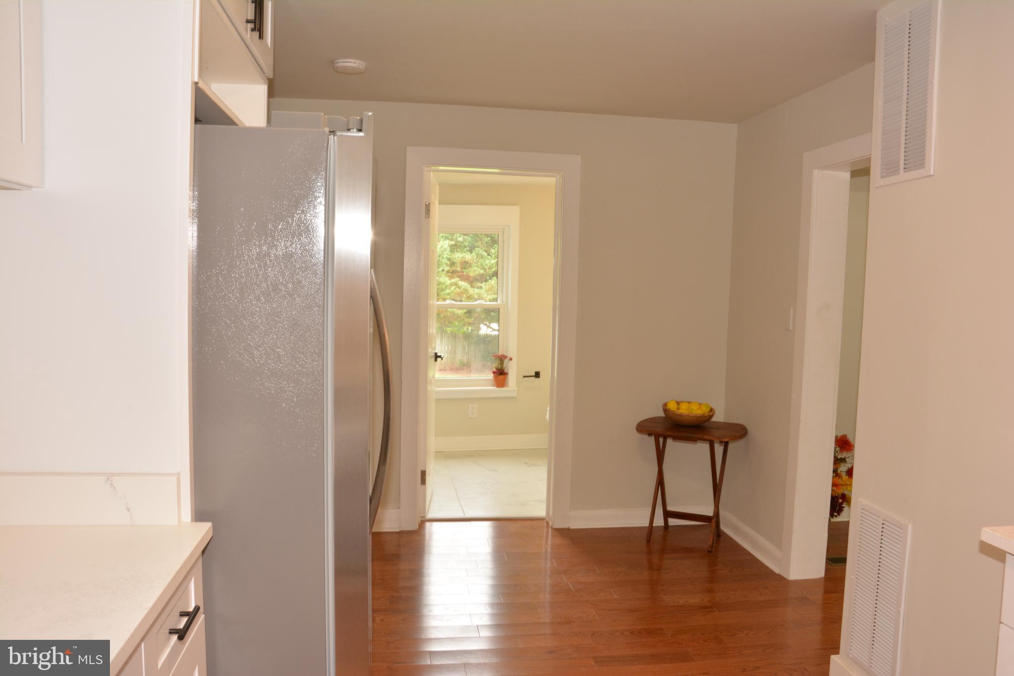 1006 Circle Drive Keymar, MD 21757 - Photo 15 of 57 a view of a hallway with wooden floor and a bathroom