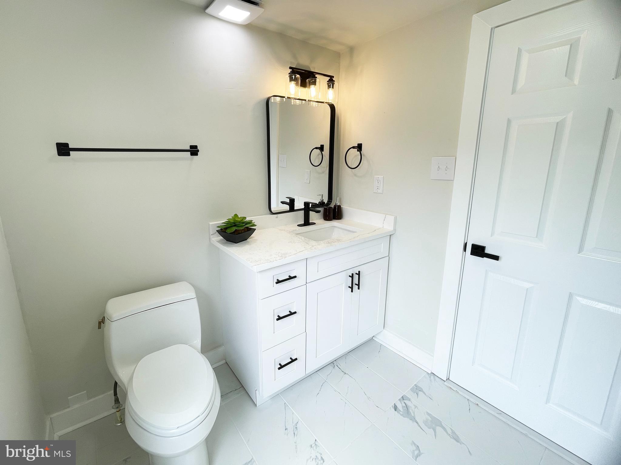 1006 Circle Drive Keymar, MD 21757 - Photo 17 of 57 a bathroom with a toilet sink and mirror