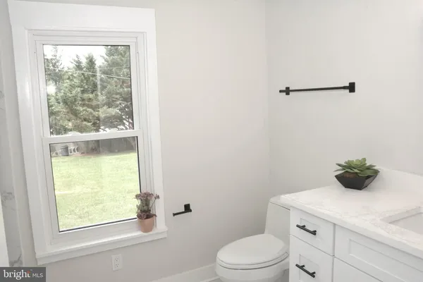 a bathroom with a toilet sink and window