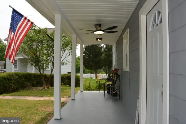 a view of a porch with chairs and backyard