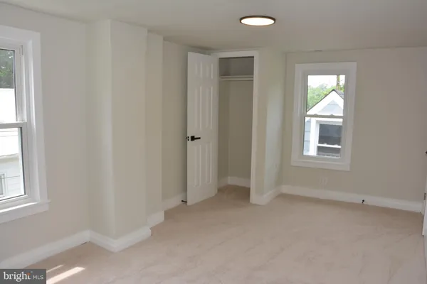 a white toilet sitting next to a window