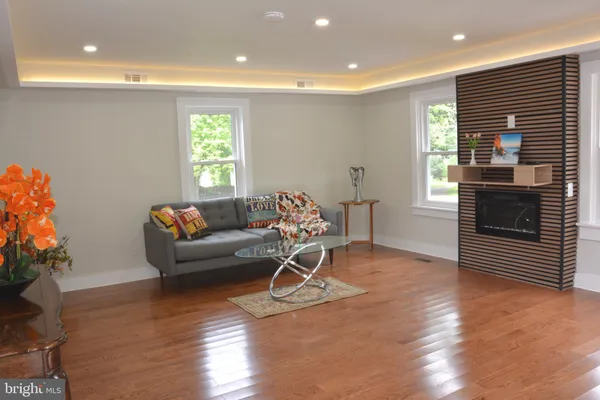 a living room with furniture and a wooden floor