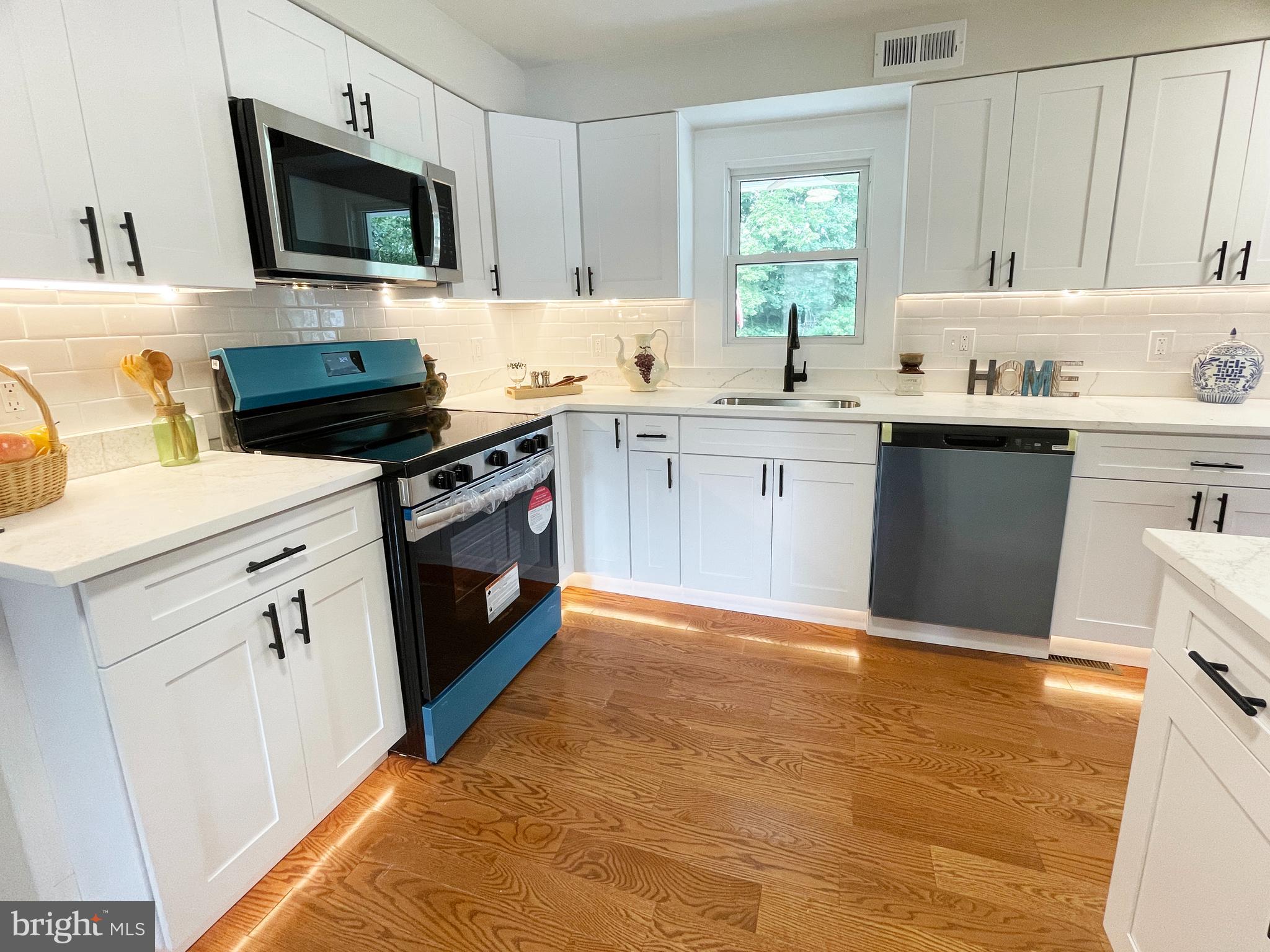 1006 Circle Drive Keymar, MD 21757 - Photo 9 of 57 a kitchen with a sink stove and microwave