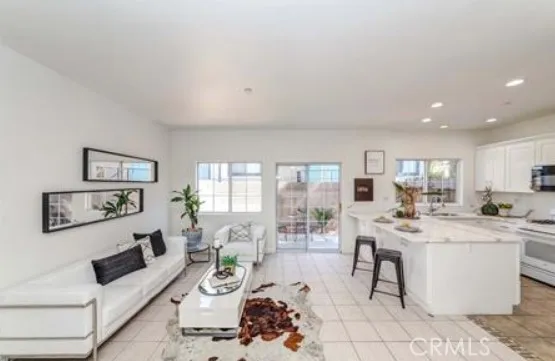 a living room with furniture a large window and table