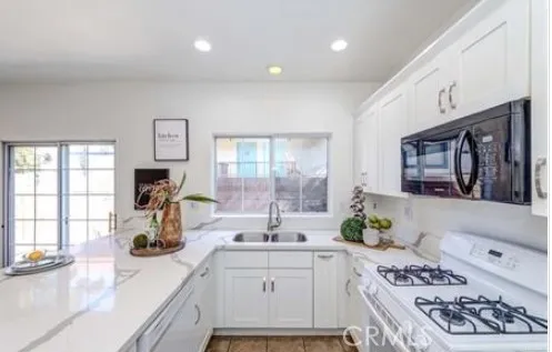 a kitchen with a sink stove and cabinets