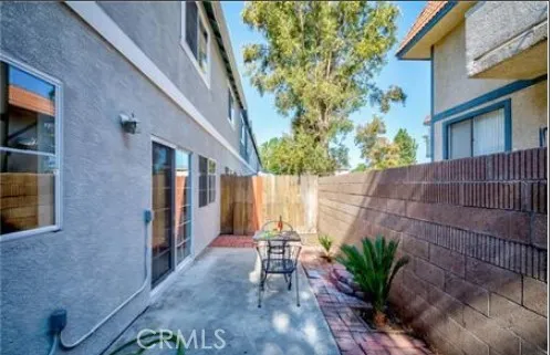 a backyard of a house with plants and outdoor seating