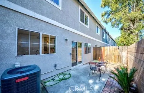 a backyard of a house with outdoor seating