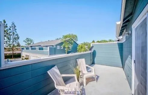 a view of a chair and table in the balcony