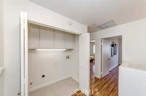 a view of a hallway with closet and bathroom