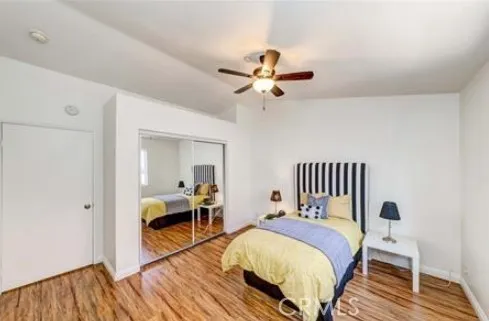 a bedroom with a bed and wooden floor