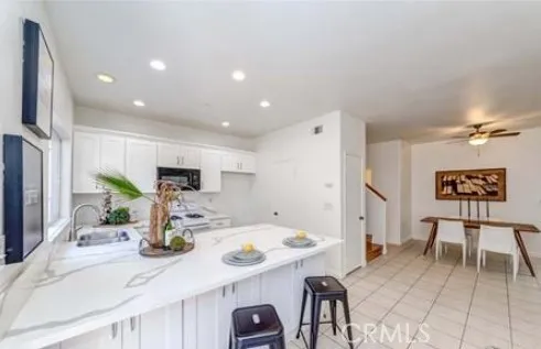 a kitchen with stainless steel appliances granite countertop a sink and a refrigerator