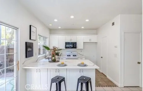 a kitchen with refrigerator and cabinets