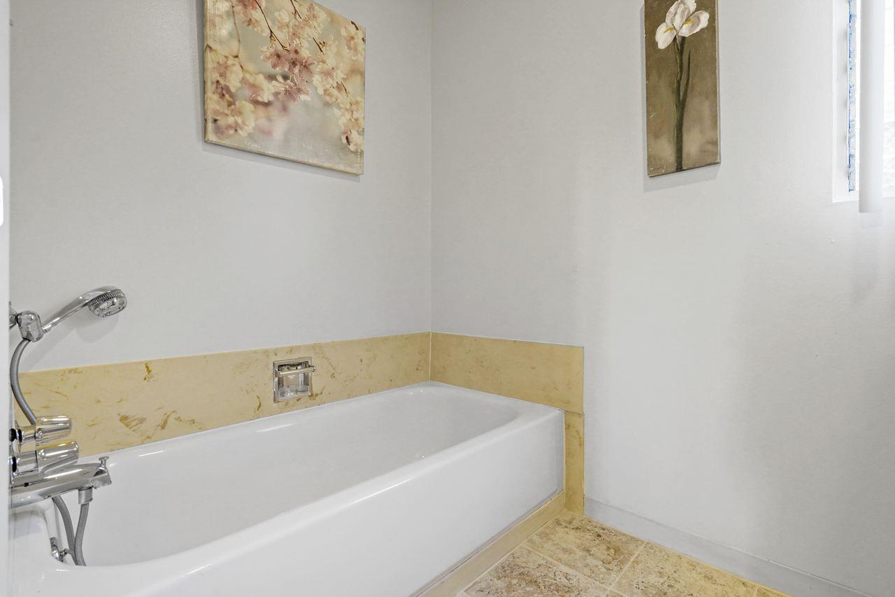 124 Del Mesa Carmel Carmel, CA 93923 - Photo 13 of 28 a bathroom with a tub and a window