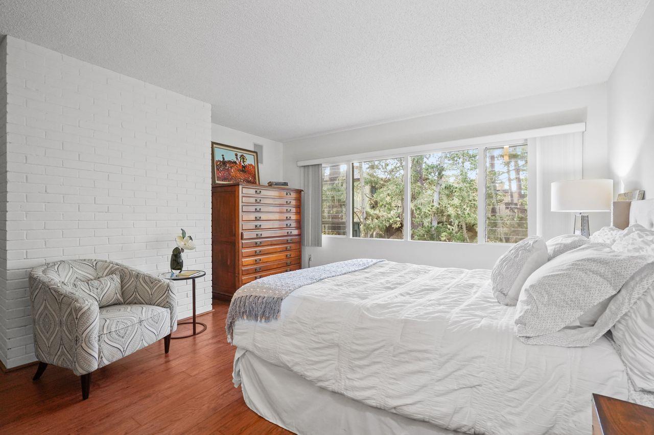 124 Del Mesa Carmel Carmel, CA 93923 - Photo 16 of 28 a bedroom with a bed couch and a large window