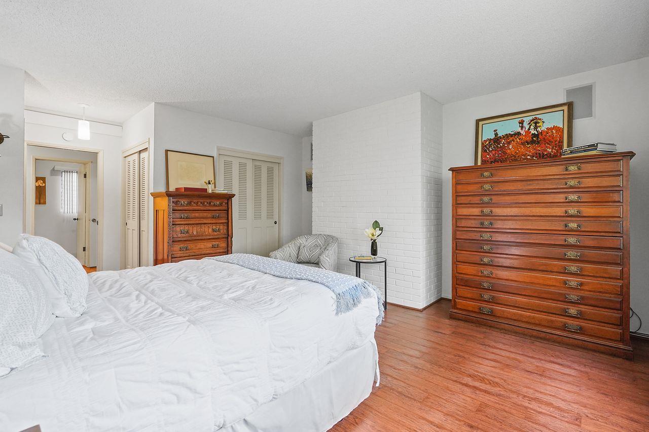 124 Del Mesa Carmel Carmel, CA 93923 - Photo 18 of 28 a bedroom with a bed and wooden floor