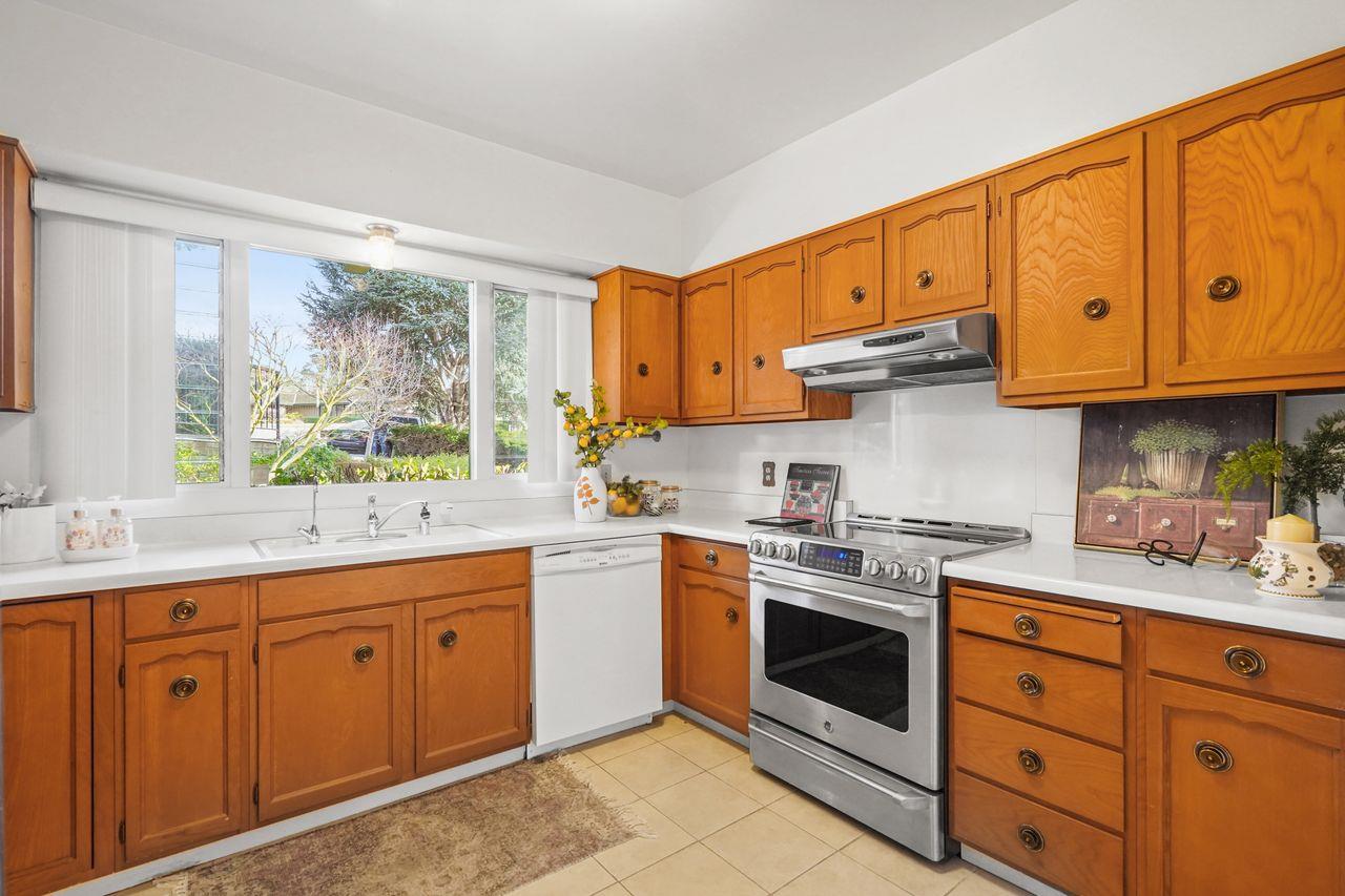 124 Del Mesa Carmel Carmel, CA 93923 - Photo 8 of 28 a kitchen with stainless steel appliances granite countertop a stove sink and cabinets