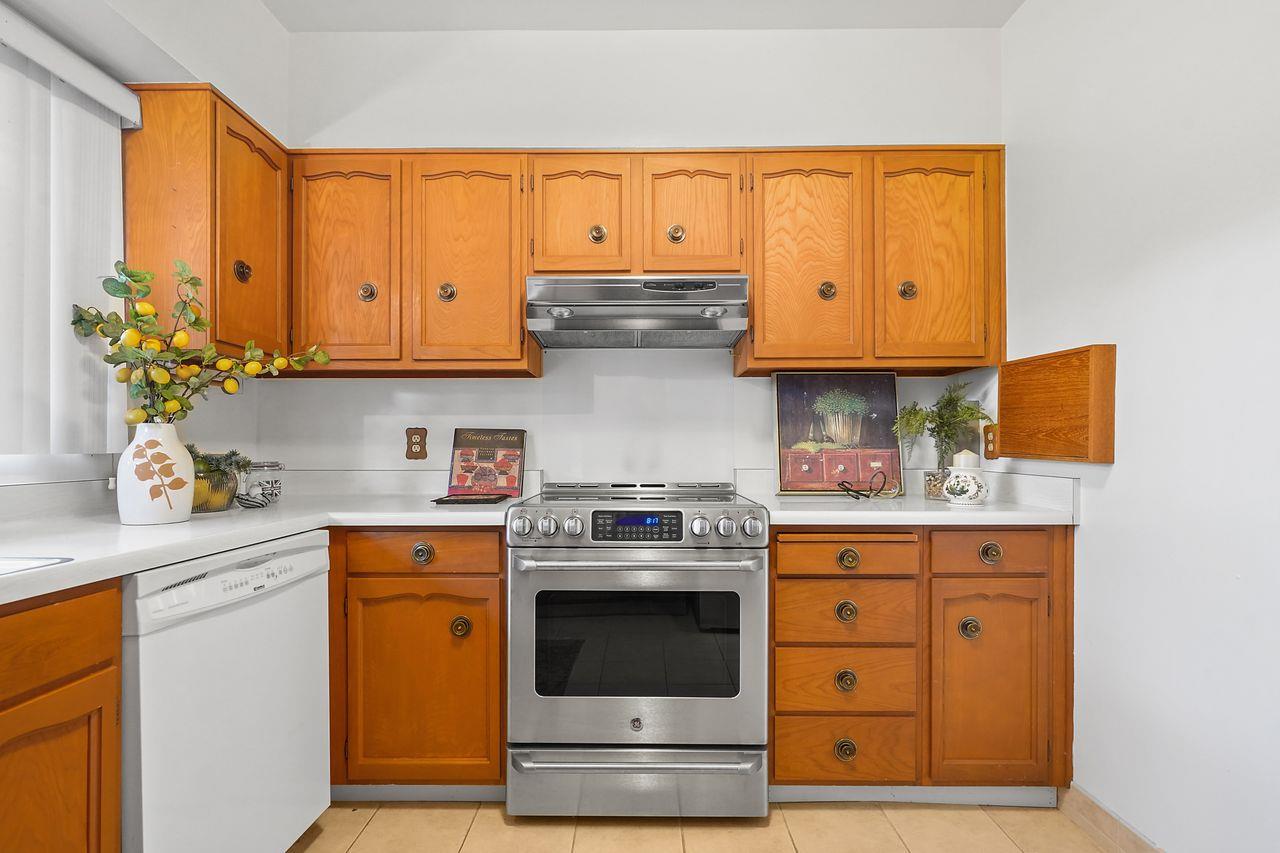 124 Del Mesa Carmel Carmel, CA 93923 - Photo 10 of 28 a kitchen with stainless steel appliances granite countertop a stove and a white cabinets