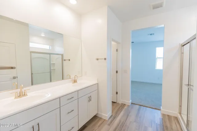 a bathroom with a double vanity sink and mirror
