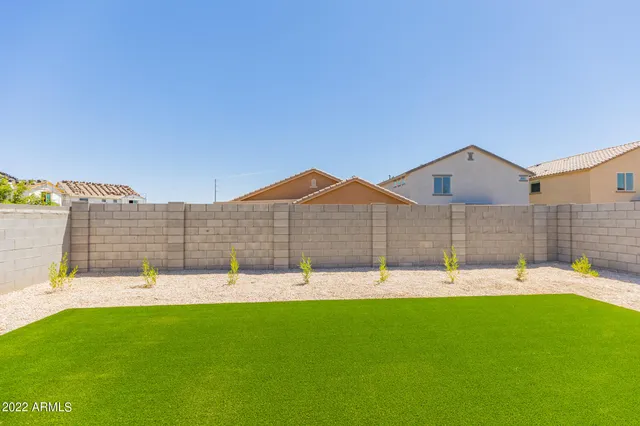 a view of a house with a yard and sitting area