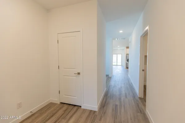 a view of a hallway with wooden floor