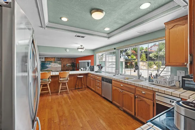 a kitchen with lots of counter top space and stainless steel appliances