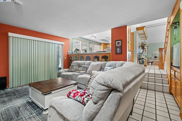 a living room with furniture and a floor to ceiling window