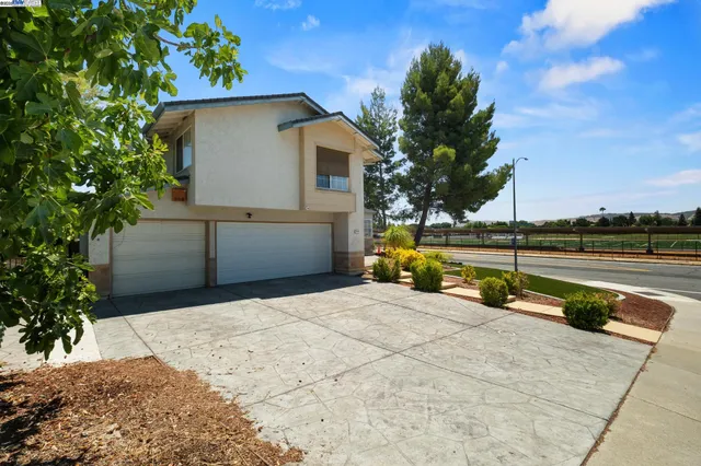 a view of backyard with swimming pool and seating